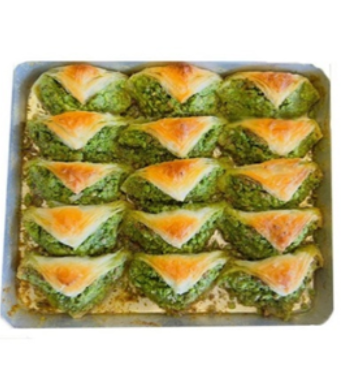 Sha'ibiyat with cream and pistachios - crispy pastry sheets filled with fresh cream and topped with crushed pistachios
