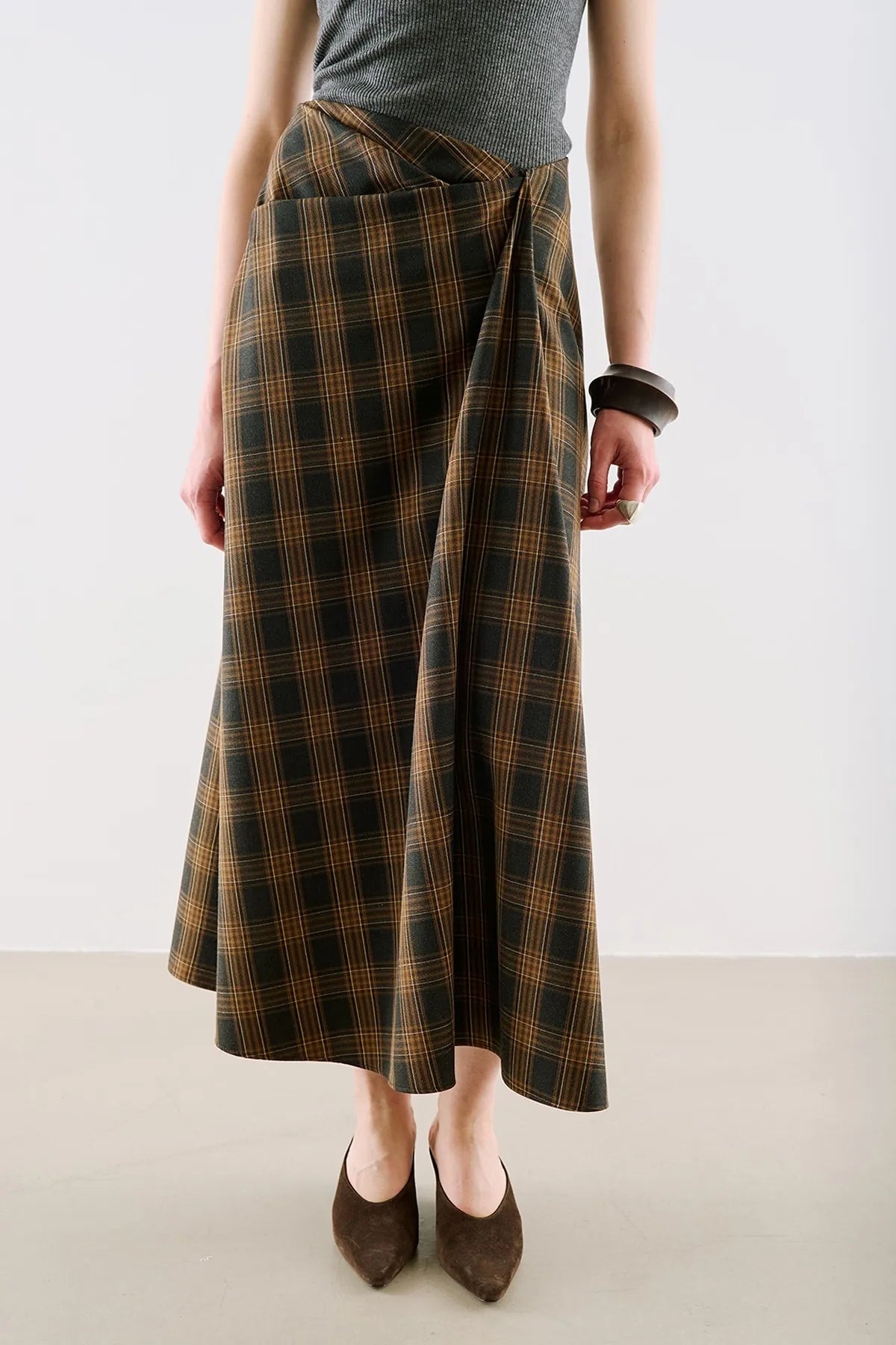 A long plaid wrap skirt in brown and black check.