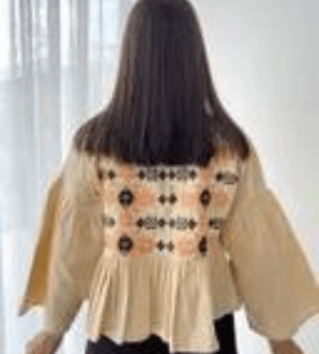 Patterned women's jacket decorated with tassels